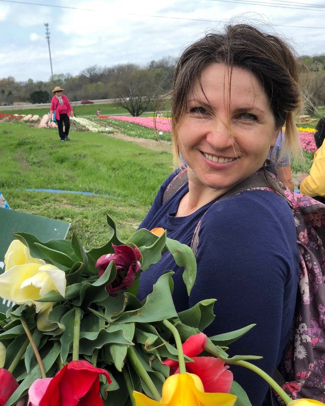 Portrait of Mila holding a bouquet of tulips