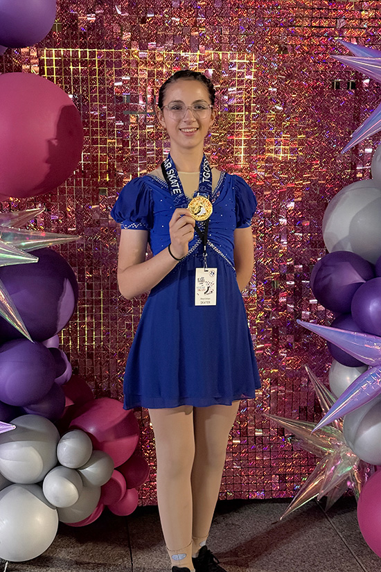 Mikayla holding a gold medal